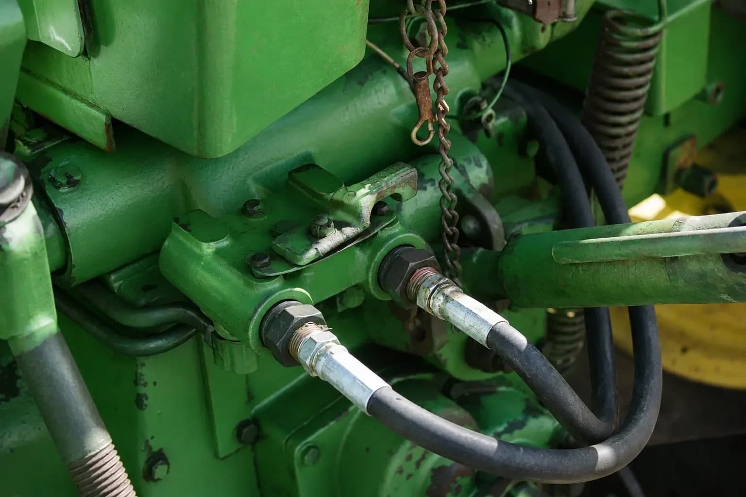 Hydraulic hoses with crimped fittings on a John Deere tractor