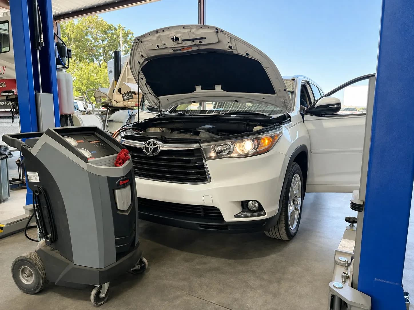 Robinair A/C recovery and recharge machine connected to an SUV during air-conditioning service at Quality Mechanics