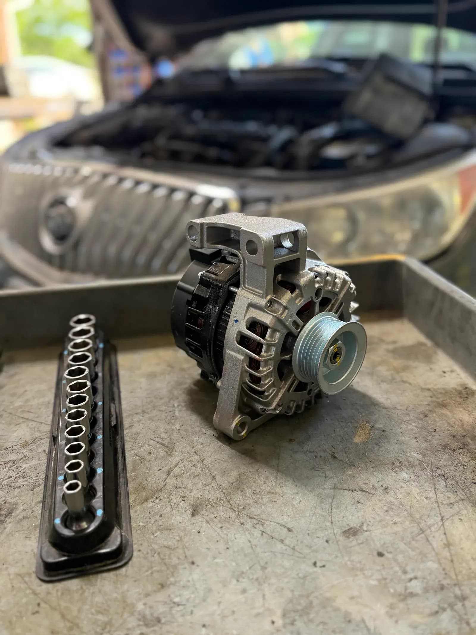 Alternator removed for testing during starting and charging system diagnosis