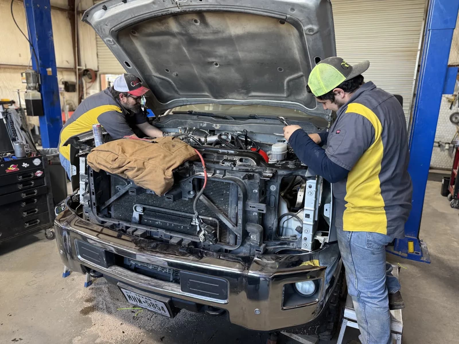Technicians replacing the radiator on a pickup at Quality Mechanics