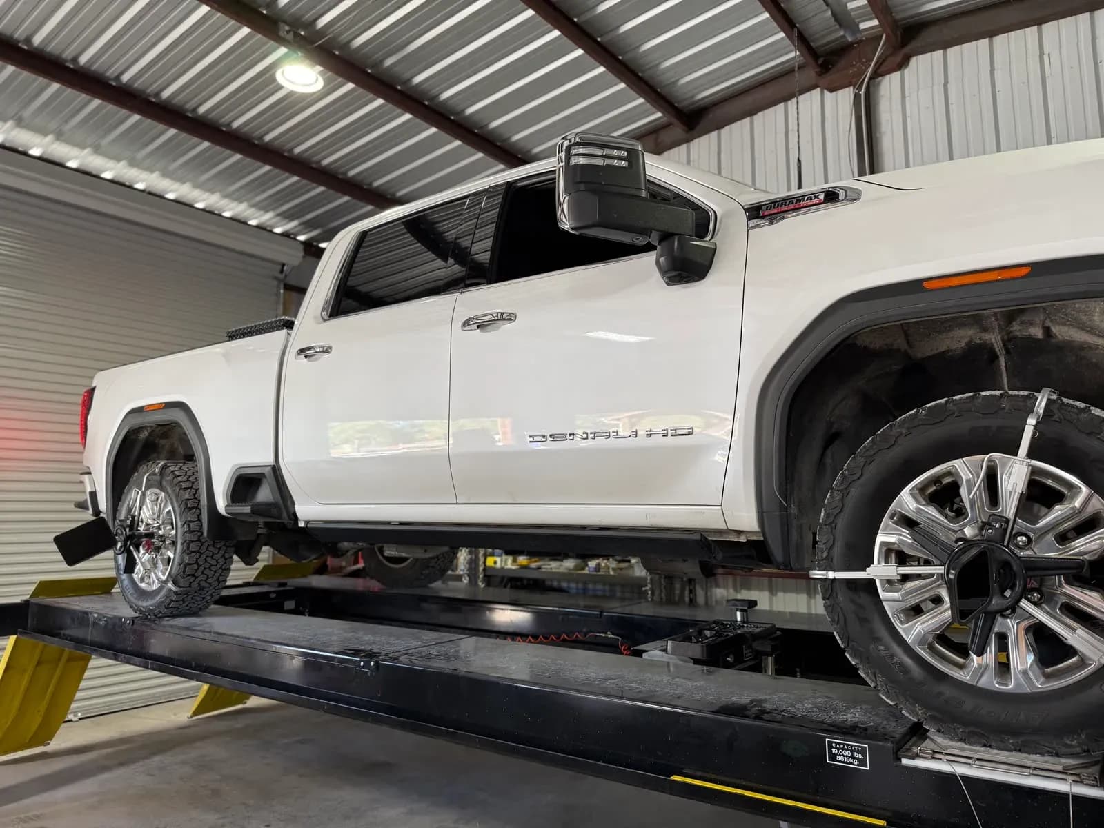 GMC dually on the alignment rack at Quality Mechanics