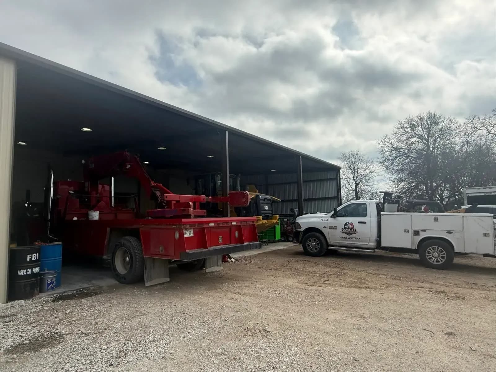 Service trucks and fleet vehicles at the Quality Mechanics yard