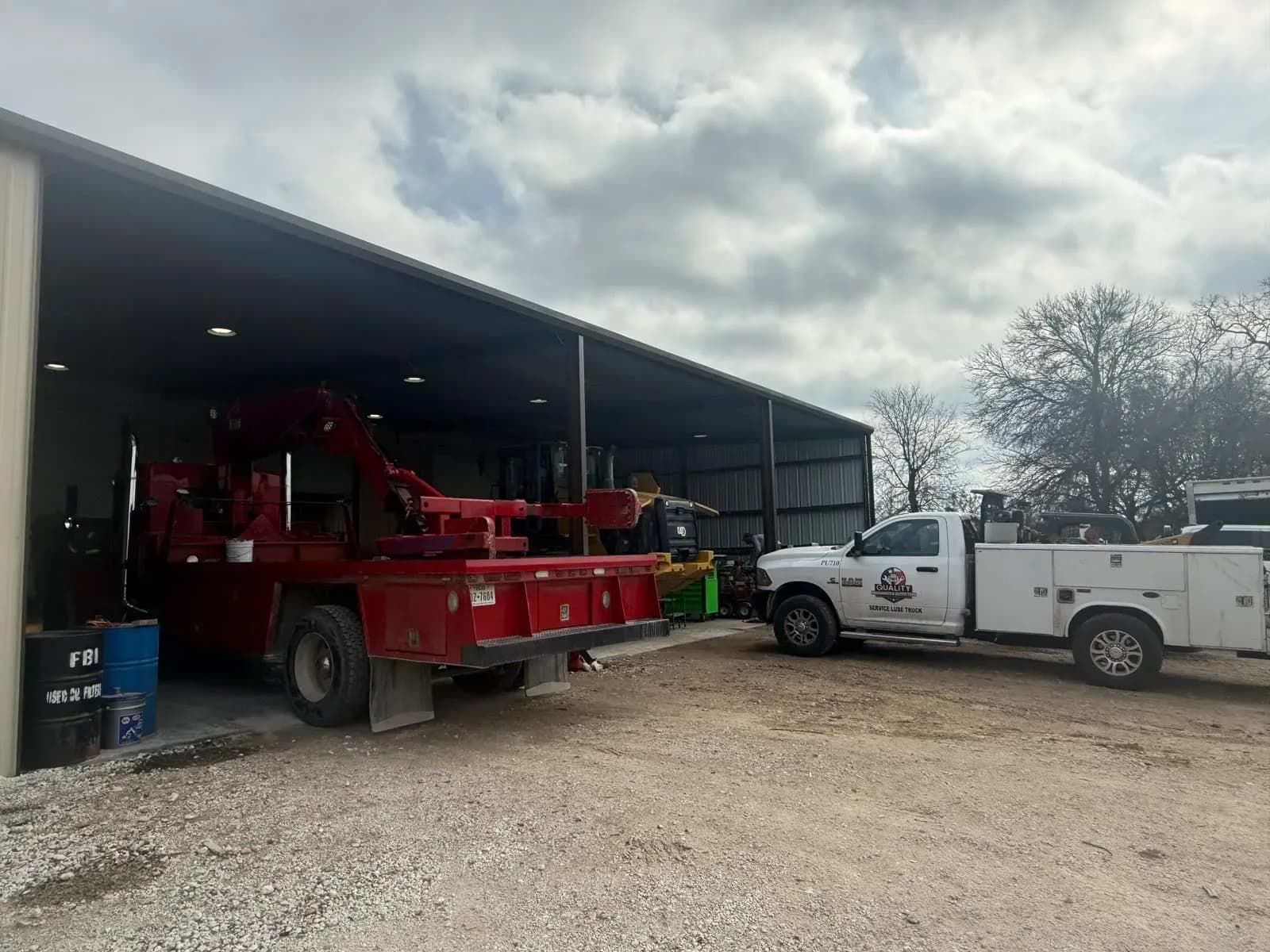 Service trucks and fleet vehicles at the Quality Mechanics yard