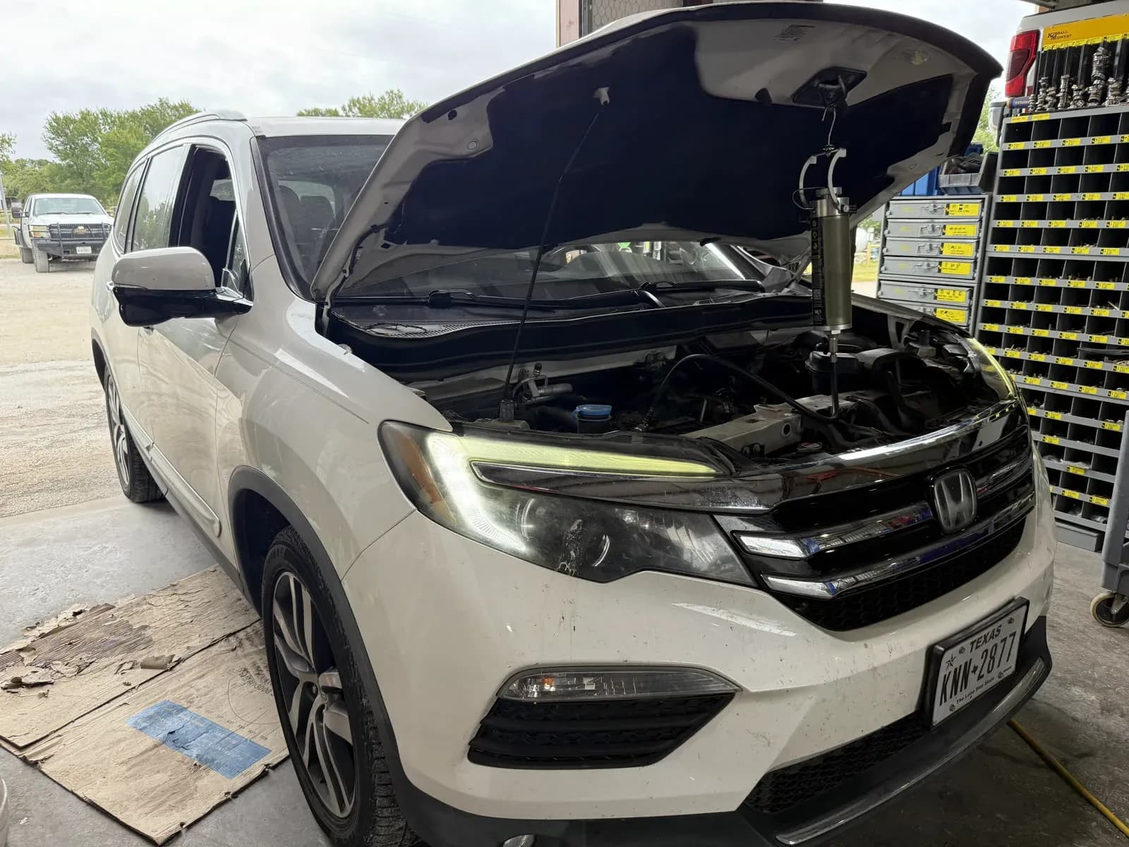 Honda SUV in the Quality Mechanics shop for scheduled maintenance
