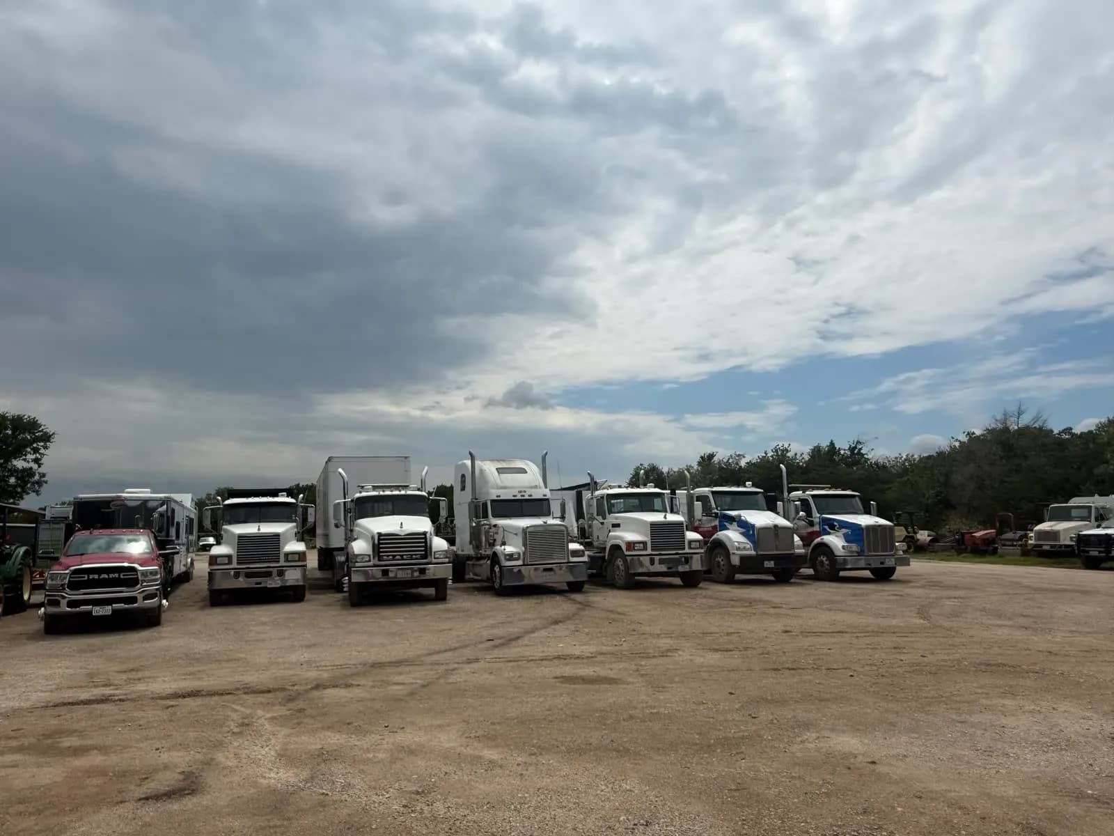 Fleet of work trucks lined up in the yard for scheduled maintenance
