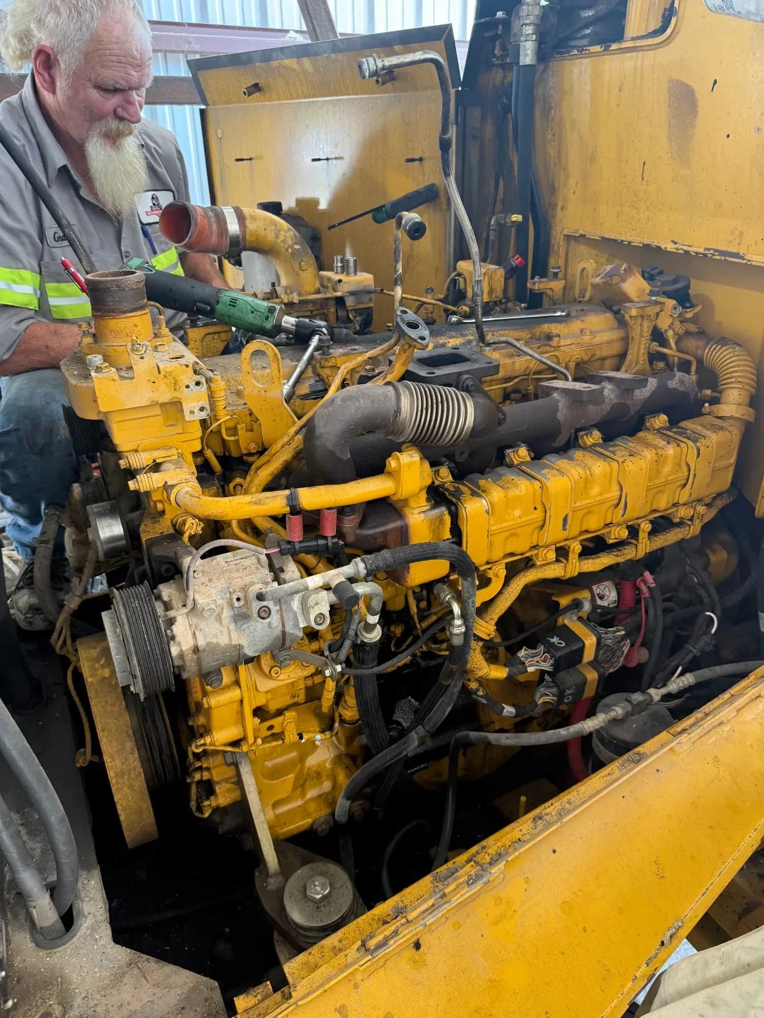 Quality Mechanics technician repairing the diesel engine of heavy equipment