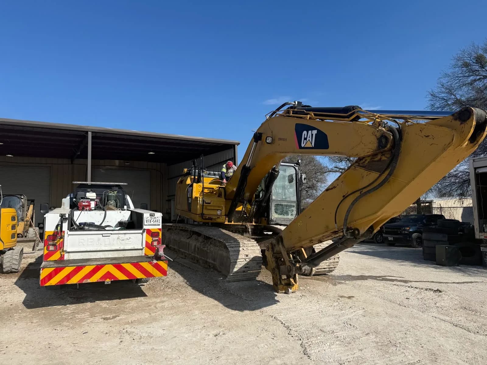 CAT excavator on a lowboy trailer at Quality Mechanics