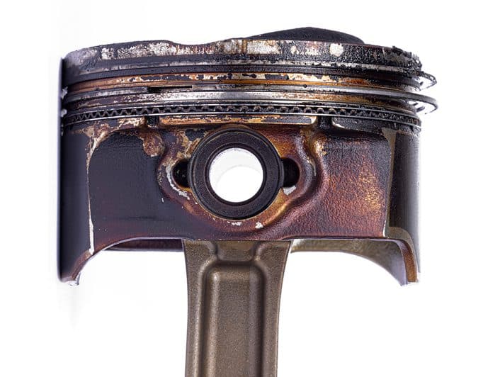 Engine piston deposit comparison — before
