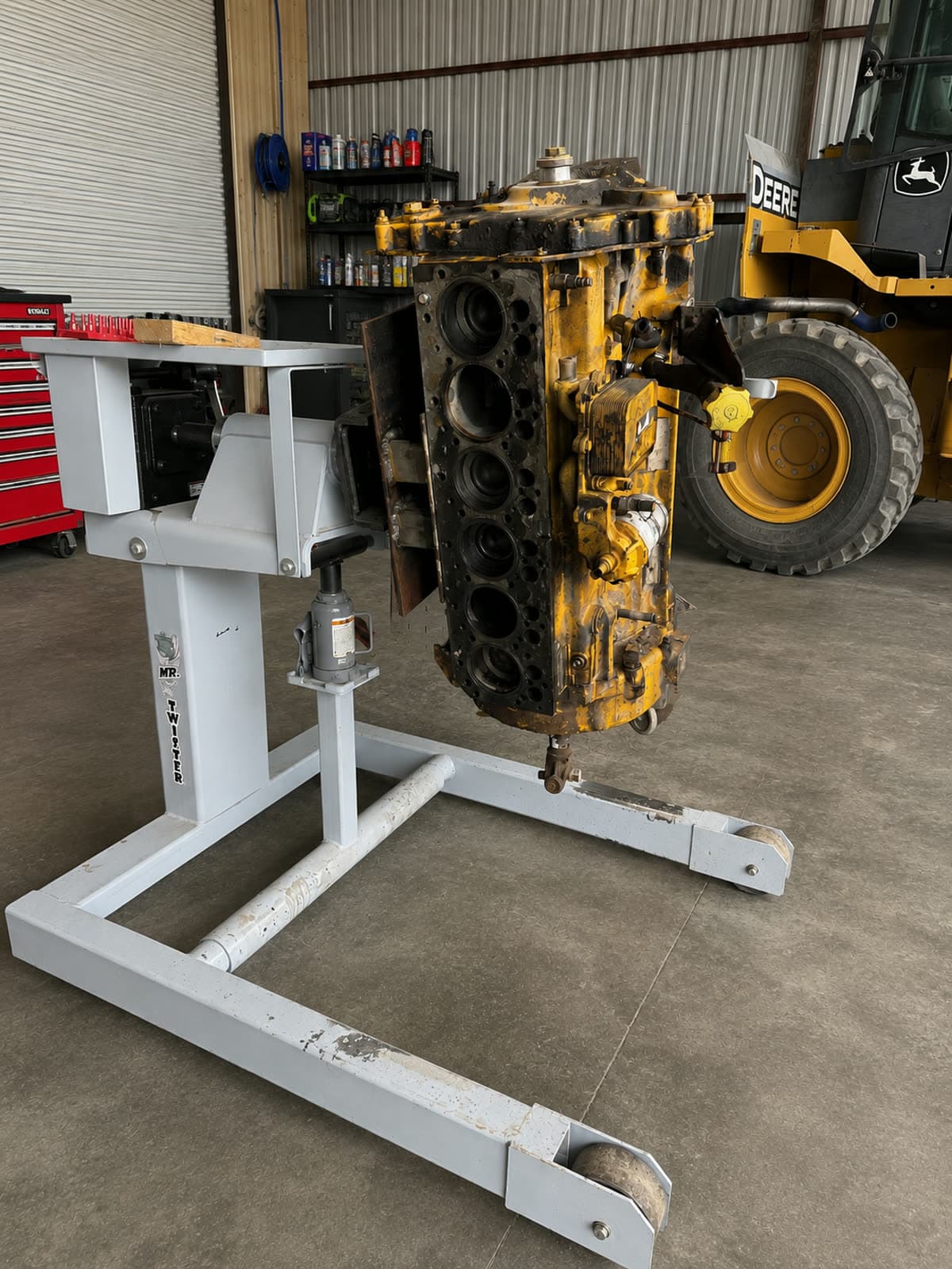 Diesel engine block from heavy equipment mounted on an engine stand in the Quality Mechanics shop