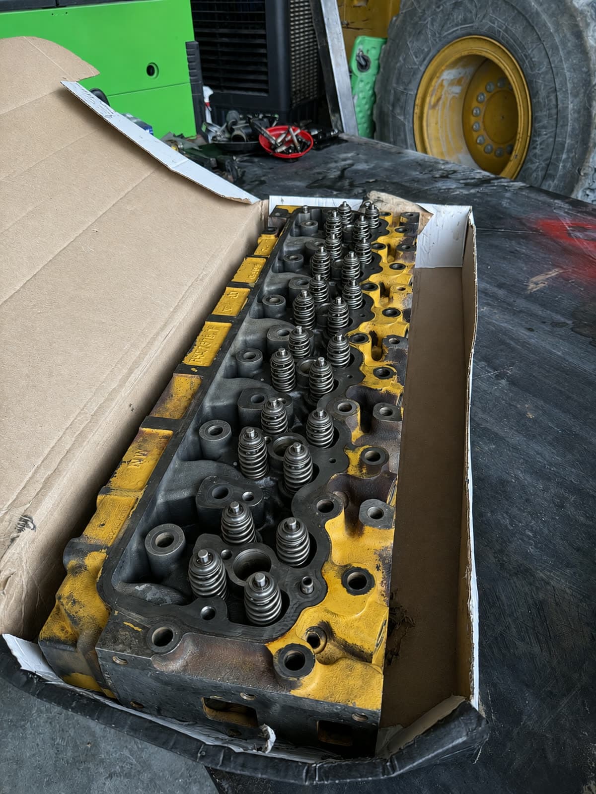 Diesel cylinder head with valve springs removed for service at Quality Mechanics