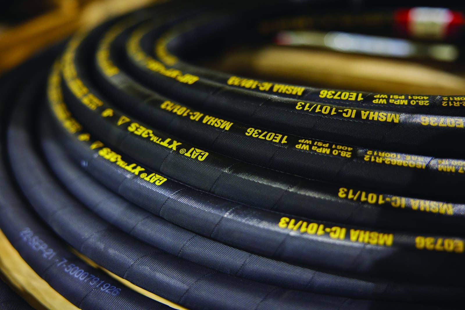 Coils of hydraulic hose with printed size and pressure specifications