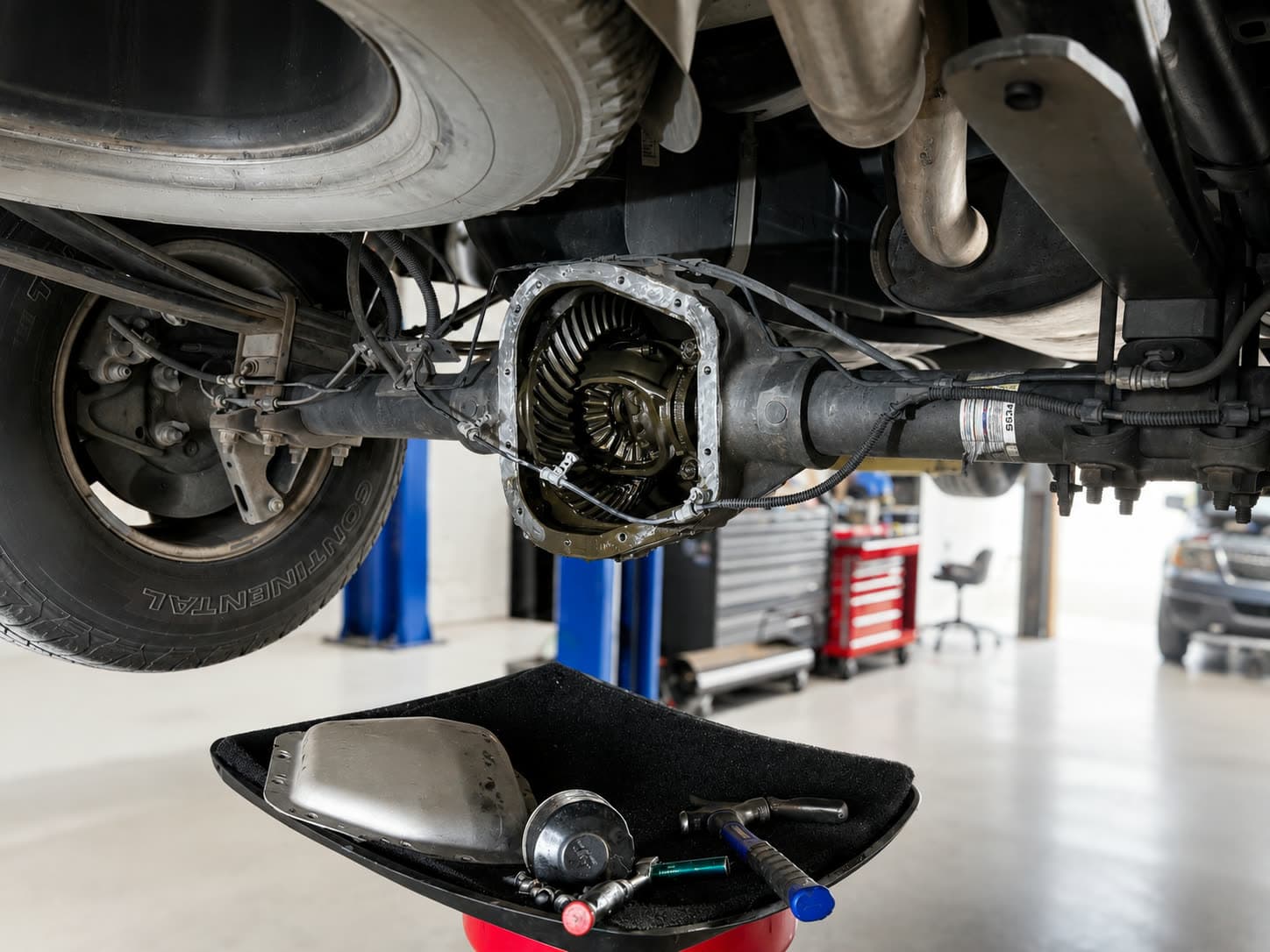 Rear differential with the cover removed showing the ring gear during service at Quality Mechanics